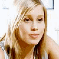 a close up of a woman 's face looking at the camera .