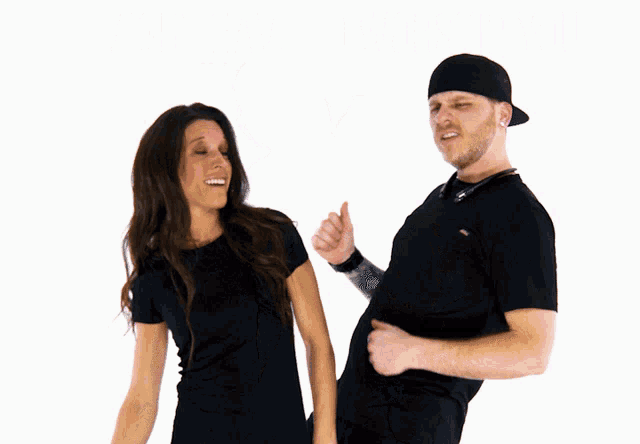 a man and a woman are standing next to each other and the man is wearing a black hat