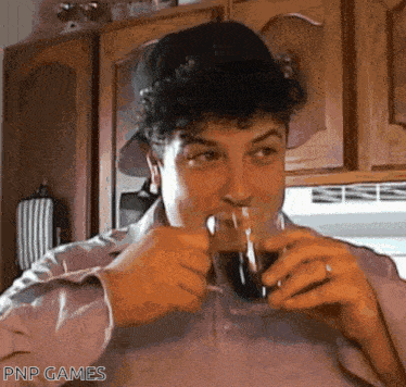 a man drinking from a glass with the words pnp games written on the bottom