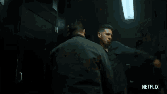 a man is laying on the floor in a dark room in a netflix ad .