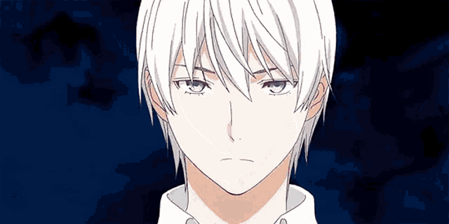 a close up of a man with white hair and blue eyes .