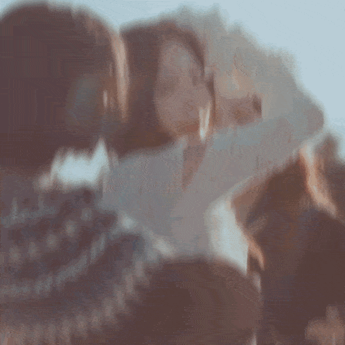 a woman in a white sweater is surrounded by two other girls