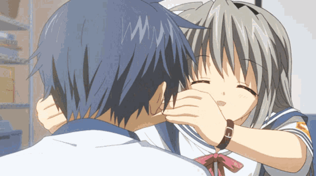 a girl with a watch on her wrist kisses a boy
