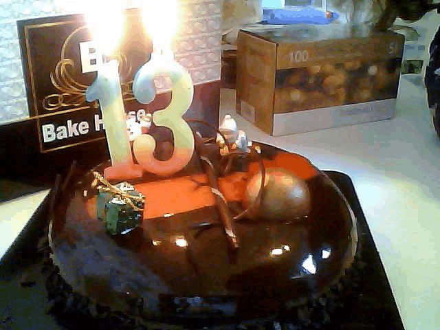 a cake with a number 13 candle on it