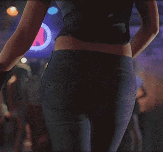 a woman 's butt is shown in a blurry photo in front of a pepsi sign