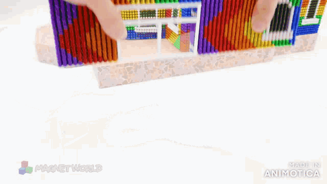 a model of a house made of magnets with the words magnet world on the bottom