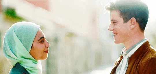 a man and a woman are looking into each other 's eyes .