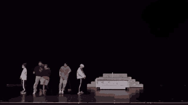 a group of people are dancing on a stage .