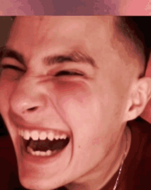 a close up of a man 's face with his mouth open and his eyes closed