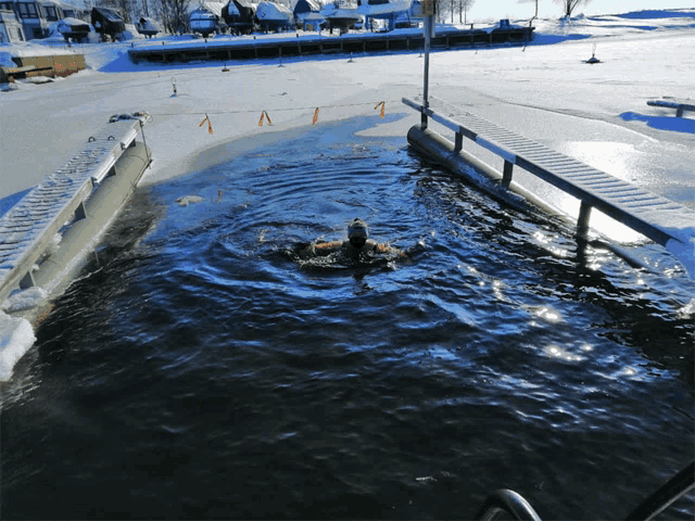 a person is swimming in a body of water with a sign that says 1 on it