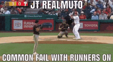 a baseball game is being played in front of a crowd and a toyota ad