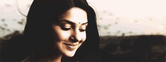 a close up of a woman 's face with a bindi on her forehead