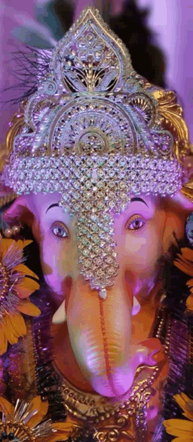 a close up of a statue of a deity with a crown on his head