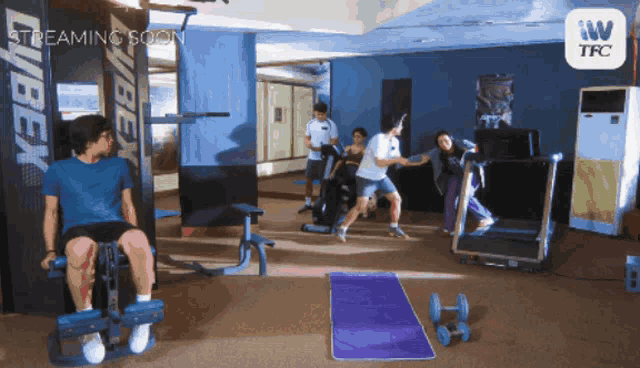 a group of people in a gym with the words streaming soon on the bottom