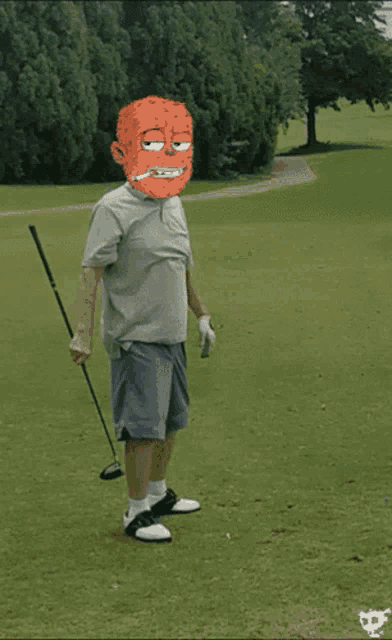 a man holding a golf club with a cartoon face on his head