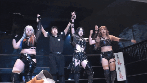 a group of women standing in a ring with a sign that says fame star fame star
