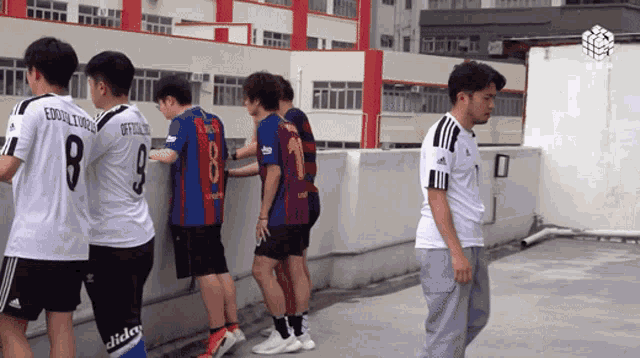 a group of soccer players one of whom has the number 8 on his jersey