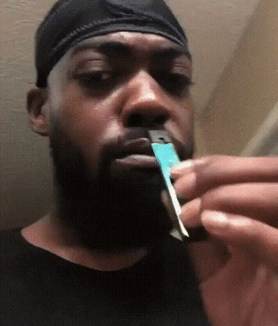 a man with a beard is holding a lighter in his hand