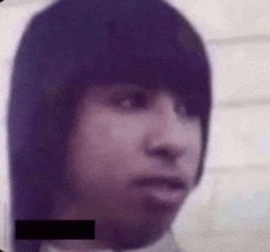 a close up of a man 's face with a purple haircut