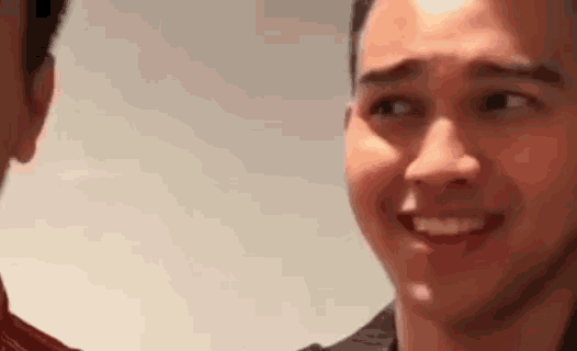 a close up of a man 's face making a funny face .