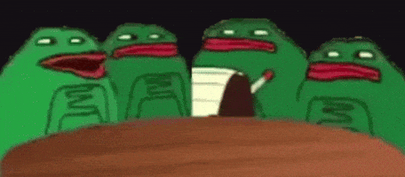 a group of green frogs are sitting around a table with a man smoking a cigarette .