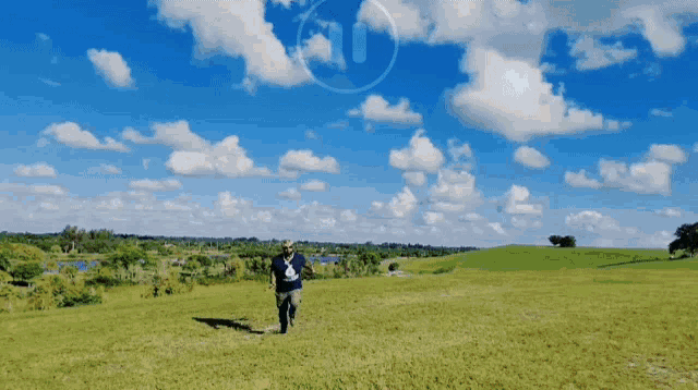 a person walking in a field with the number 10 visible in the sky