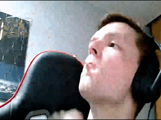 a man wearing headphones is sitting in a chair looking up