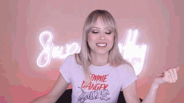 a woman wearing a t-shirt that says i 'm a tiger making a face