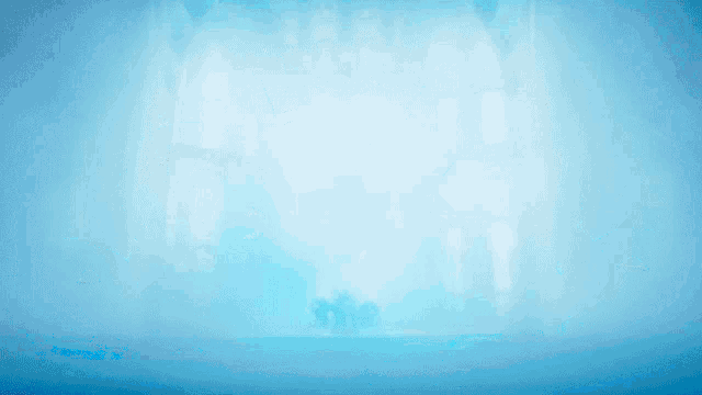 a blue penguin with a crown on his head is surrounded by other blue penguins