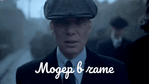 a man in a suit and hat is standing in front of a sign that says mogep b rame