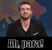 a man in a suit says ah para in front of a map