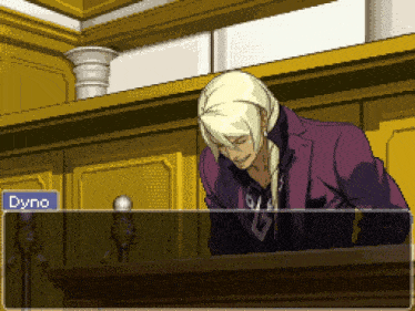 a man in a purple suit stands at a podium with the name dyne written on the screen