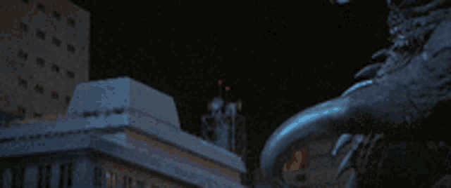 a monster is standing in the dark with smoke coming out of his mouth .