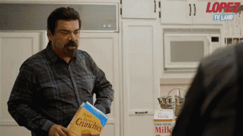 a man is holding a bag of crunchies in his hand