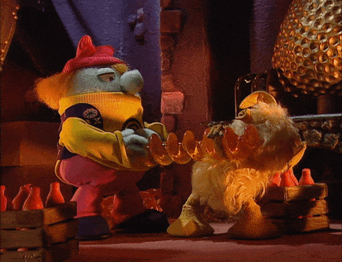 two stuffed animals are standing next to each other and one is wearing a yellow jacket