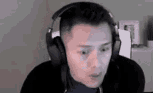 a man wearing headphones is making a funny face .