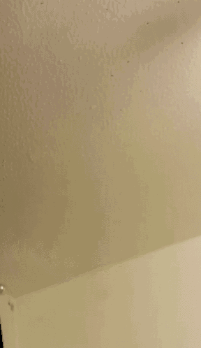 a close up of a white surface with a shadow of a person .
