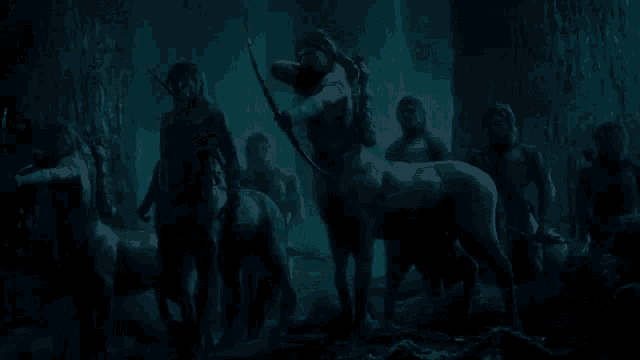a group of centaurs standing in a dark cave