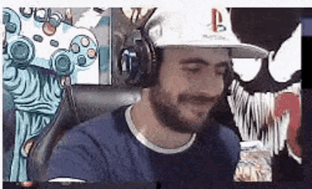 a man with a beard is wearing headphones and a hat while sitting in front of a video game controller .