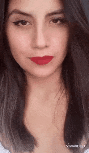 a close up of a woman 's face with red lipstick on her lips .