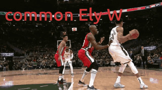 a basketball game is being played in front of a banner that says " common ely "