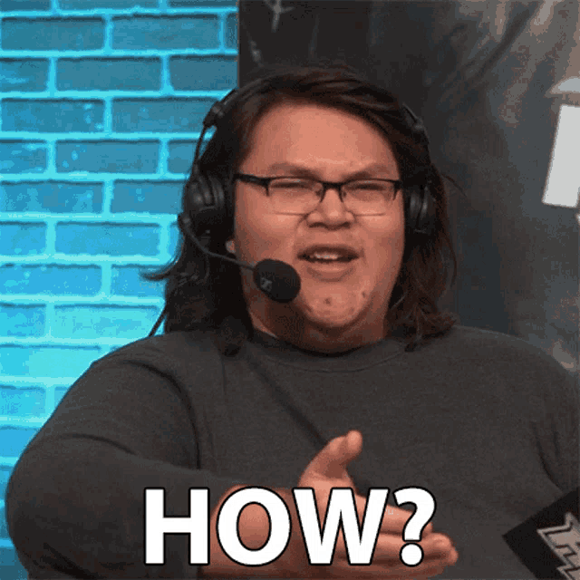 a man wearing headphones and glasses says how in front of a brick wall
