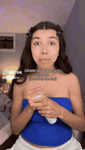 a woman in a blue top says grwm to hangout with friends