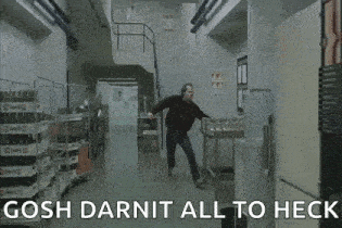 a man is walking down a hallway in a kitchen in a movie .