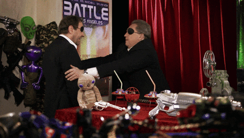 two men are standing in front of a sign that says battle
