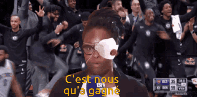 a man with a bandage on his eye and the words c'est nous qu'a gagne