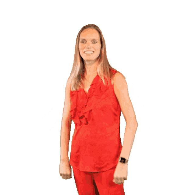 a woman in a red top and red pants is dancing