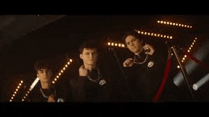 a group of young men are standing next to each other on a stage .