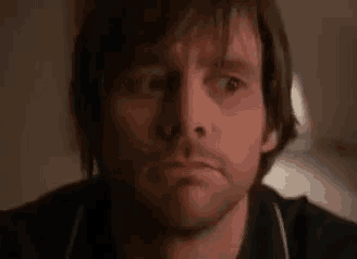 a close up of a man 's face with his eyes closed .