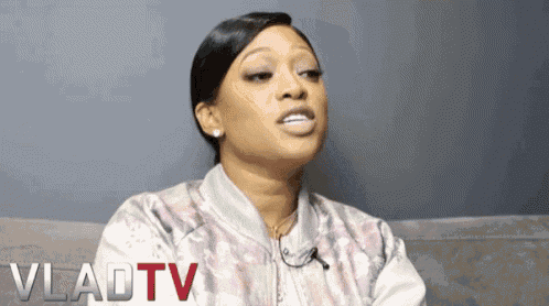 a woman sitting on a couch with vladtv written on the bottom